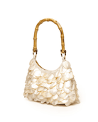 Cream-colored handbag with overlapping mother-of-pearl shell embellishments and bamboo handle in a hobo style silhouette