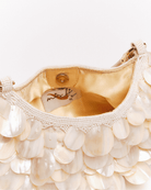 Cream beaded handbag with mother-of-pearl shell disc embellishments and gold satin lining, shown open with magnetic closure