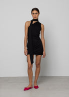 Black halter mini dress with tie neck detail, ruched silhouette, worn with hot pink satin flats.