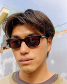 Person wearing sunglasses with a blurred background