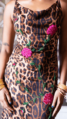 Leopard print slip dress with pink sequin floral embroidery and green leaf details, featuring a cowl neckline