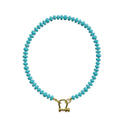 Turquoise beaded bracelet with gold-tone horseshoe clasp and natural stone variations
