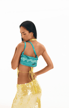 Turquoise sequined shoulder bag with adjustable straps worn with yellow sequined skirt and matching choker