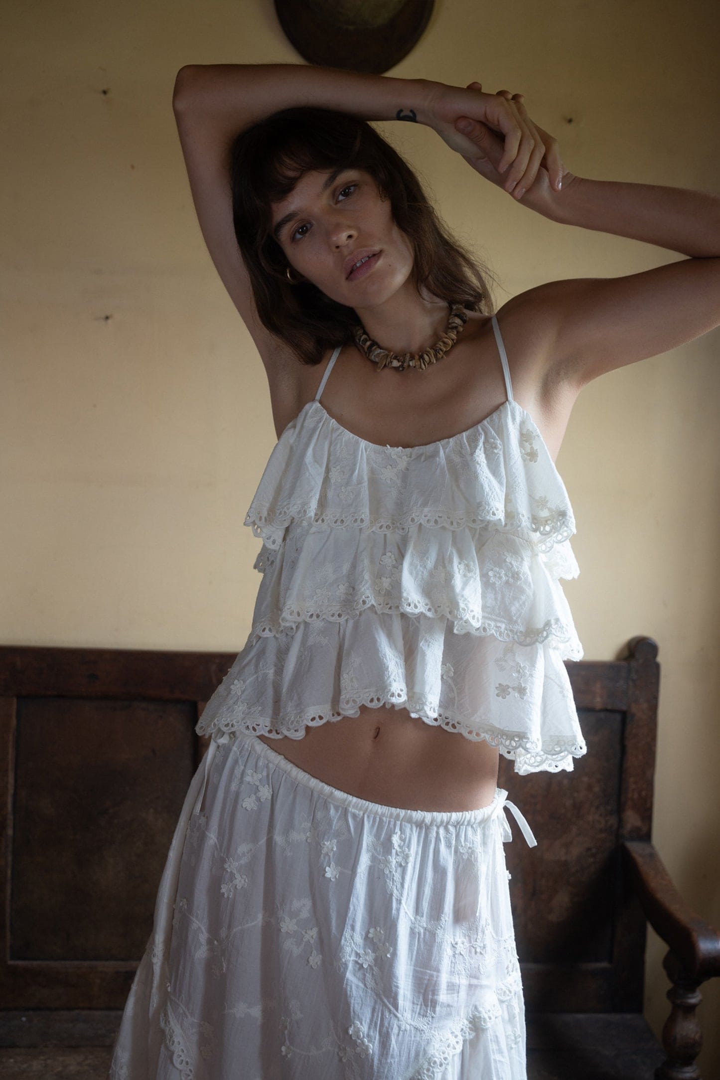White tiered ruffle eyelet lace crop top with adjustable spaghetti straps and matching high-waisted skirt set