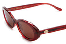 Red transparent oval sunglasses with brown lenses and gold logo detail on temple