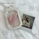 Pink cellulose acetate hair clip with wavy edges on white Christian Dior tray next to polaroid photo