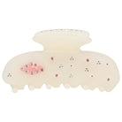 Cream-colored hair claw clip with pink and clear rhinestone embellishments scattered across the surface