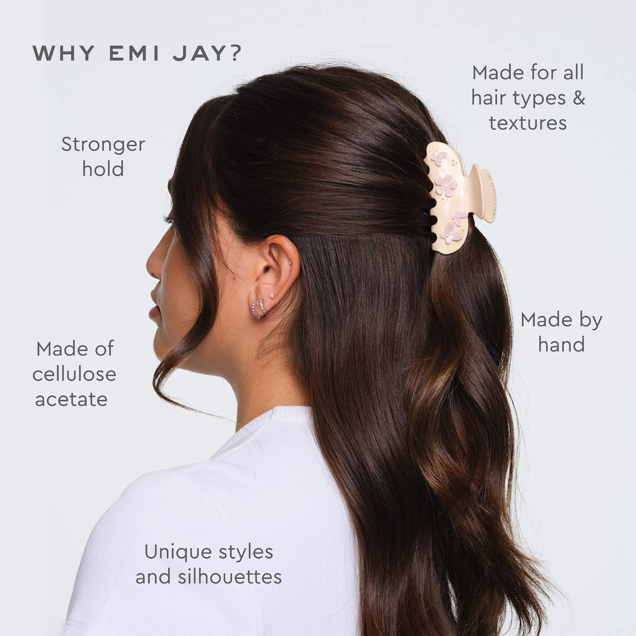 Woman with long dark hair wearing a beige floral hair claw clip, showing product features and benefits of Emi Jay hair accessories