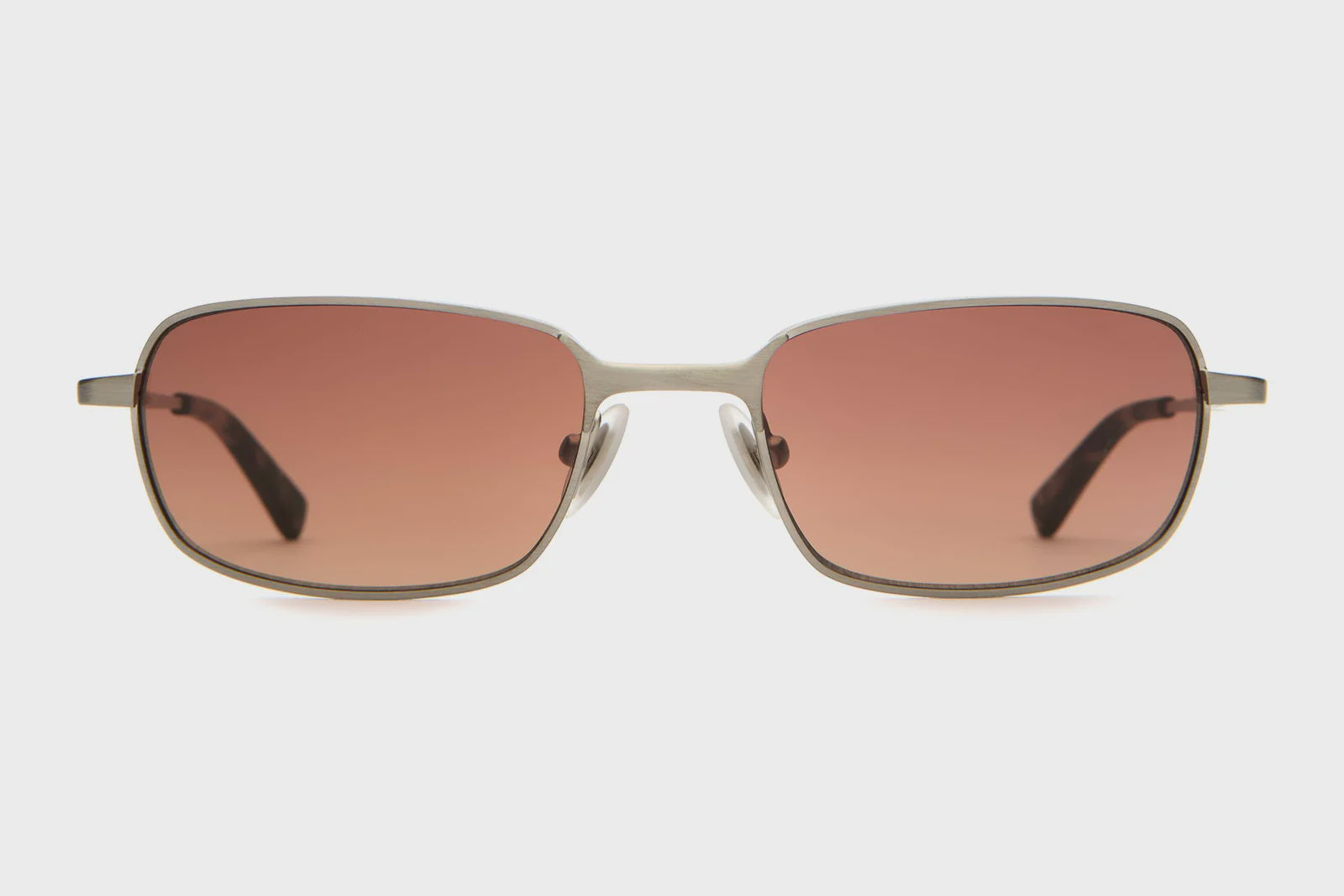 Sunglasses with gold frame and brown lenses on a white background