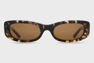 Sunglasses with tortoiseshell frame and brown lenses on a light gray background