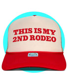 Trucker hat with red text reading "THIS IS MY 2ND RODEO" on tan front panel, red brim, and turquoise mesh back